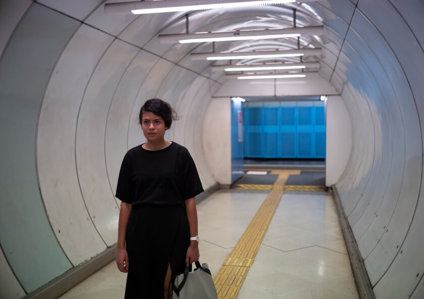 STORY mag, woman walking at a train station
